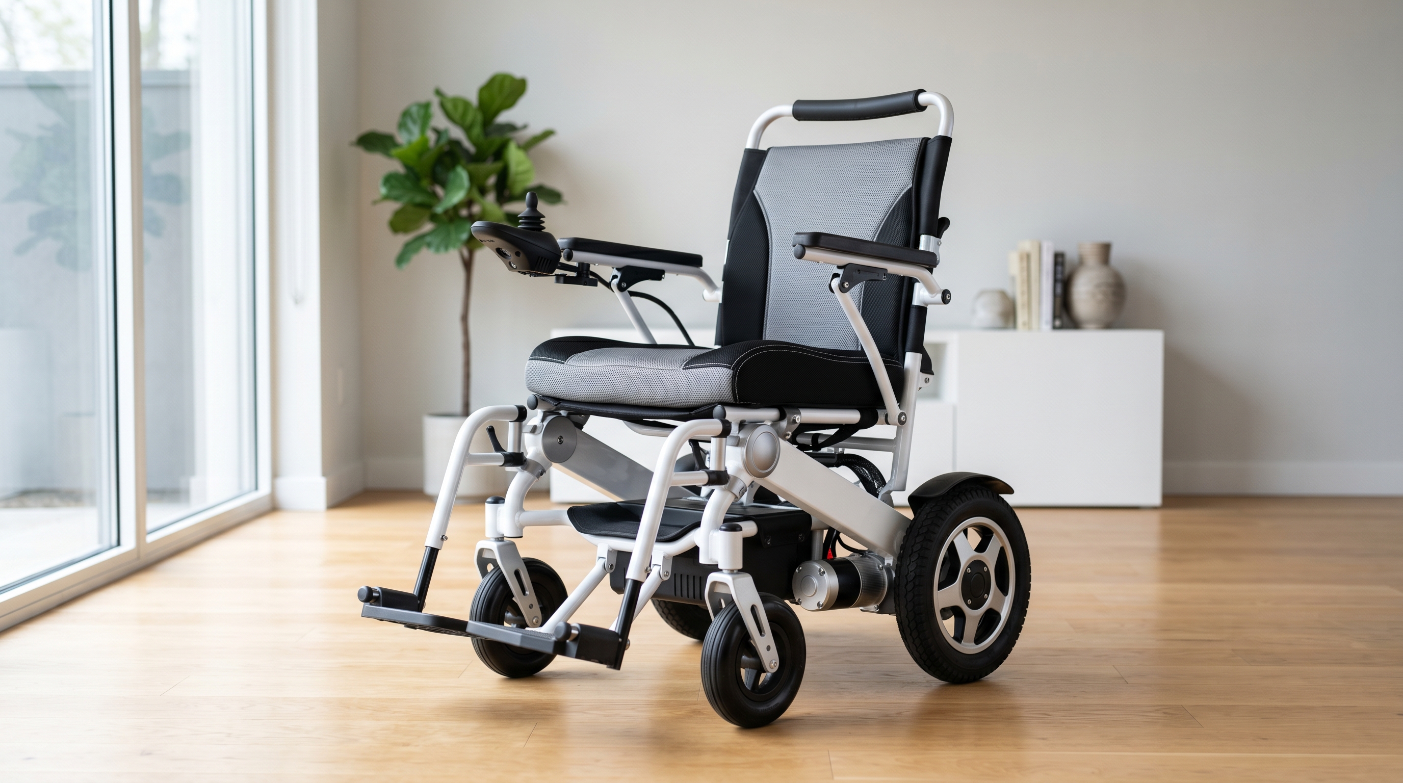 Modern folding electric power wheelchair in white and silver displayed in a clean bright showroom